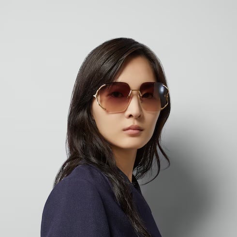 Model in gold rimless Gucci sunglasses from the Vision by Amel gallery